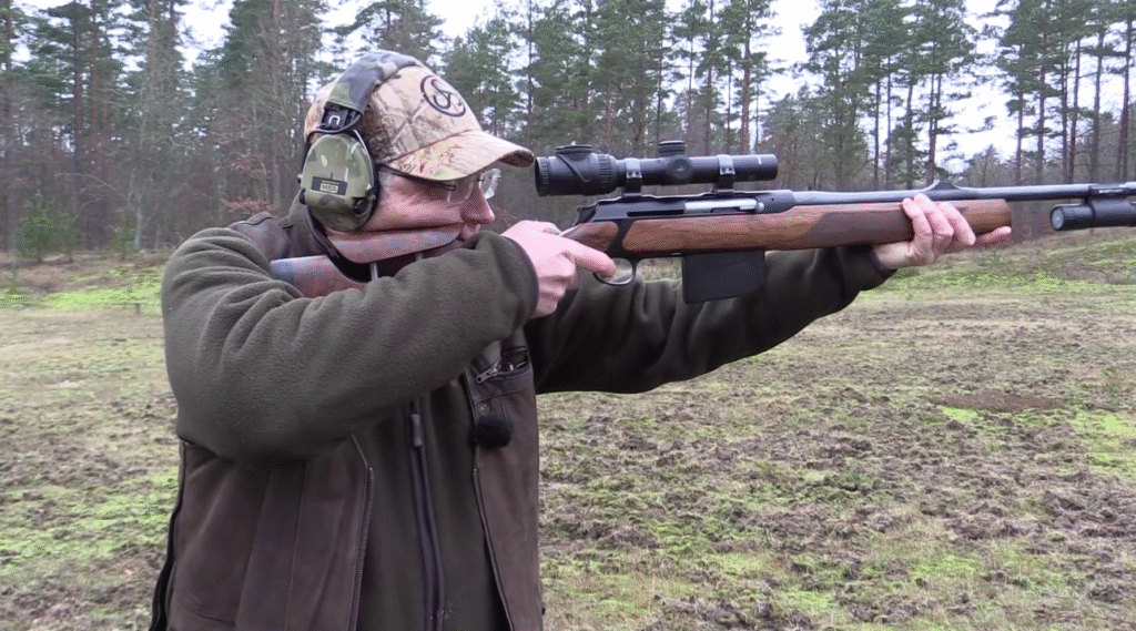 A hunter using 10x42 binoculars to scout for deer, an essential piece of hunting gear - Dealibrium